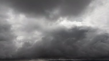 Karanlık gökyüzü bulutlarının zaman akışı. İHA 'dan gökyüzüne doğru uçan kara bulutların görüntüsü. Fırtınalı bulutlu arkaplan.