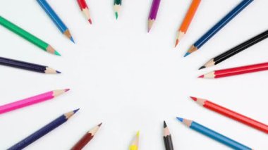 Stop motion animation with colored pencils moving moving in a fun circle. Time-lapse animation of colorful school pencils and fun pictures. Education concept