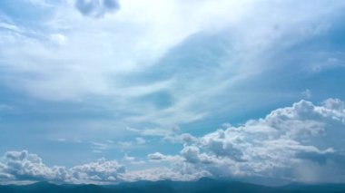 Yazın beyaz bulutlu mavi gökyüzünün havadan görünüşü. Beyaz bulutlar ve güneşli mavi gökyüzü. Doğal arka plan hareket halinde. İHA çekim bulutları hareket zamanı