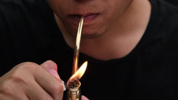Asian Man Smokes Marijuana Pipe Home Studio Shoot Model Simulating — стоковое видео