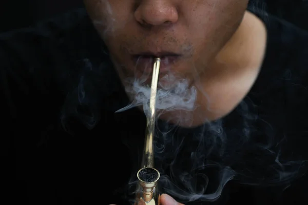 Asian Man Smokes Marijuana Pipe Home Studio Shoot Model Simulating — стоковое фото