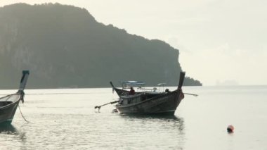 Fisherman prepares his fishing boat to go fishing in the morning. Lifestyle of Asian fishermen on wooden boats to catch saltwater fish at sea.