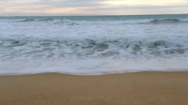 Beautiful sea waves and white sand beach in the tropical island. Beautiful view of the sunsets over sea. Ocean beach sunrise and dramatic colorful sky clouds