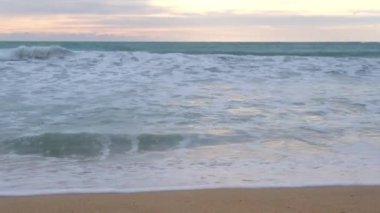 Beautiful sea waves and white sand beach in the tropical island. Beautiful view of the sunsets over sea. Ocean beach sunrise and dramatic colorful sky clouds