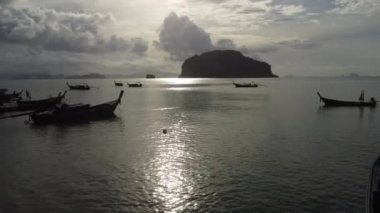 Aerial view from drones of fishing boats in the shore during low tide. Top view of many Thai traditional longtail fishing boats in the tropical islands. A lot of long tail boat on sea
