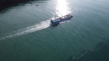 Luxury yachts or ferries sail in the Andaman Sea from Koh Yao Yai to the pier in Phuket, Thailand. Travel and transportation concept.