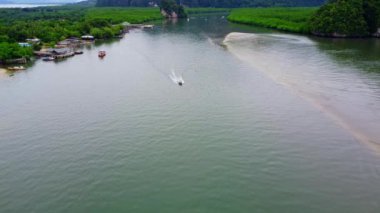 Aerial view from a drone of a white boat sailing on the blue sea Top view of a speedboat moving at high speed in the ocean