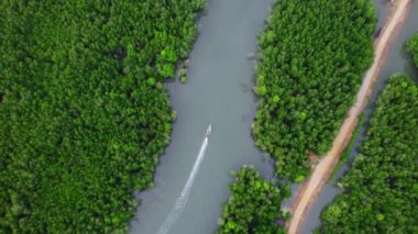 Aerial view of a Thai traditional longtail boat sailing in Phang Nga Bay among the fertile mangrove forests of the Andaman Sea, Thailand. Samet Nangshe