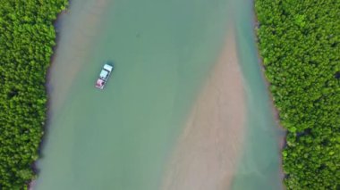 Aerial view of a Thai traditional longtail boat sailing in Phang Nga Bay among the fertile mangrove forests of the Andaman Sea, Thailand. Samet Nangshe