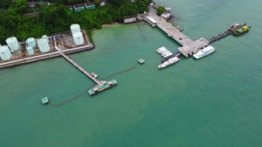 Aerial view from drone of commercial ship and cruise ship parked in the marina. Transportation and travel background, beautiful sea in summer.