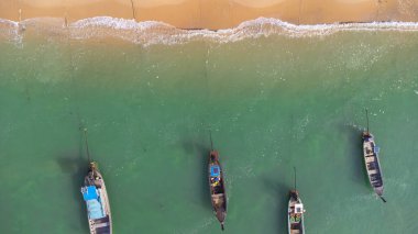 Many fishing boats near the seashore in tropical islands. Pier of the villagers on the southern island of Thailand. top view from drones.