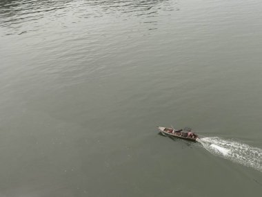 Aerial view from a drone of Thai traditional longtail fishing boats sailing in the sea. Top view of a fast moving fishing boat in the ocean.
