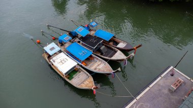 Aerial view of Thai traditional longtail fishing boats at the pier. Transportation and travel concept.