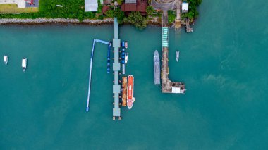 Aerial view from drone of commercial ship and cruise ship parked in the marina. Transportation and travel background, beautiful sea in summer.