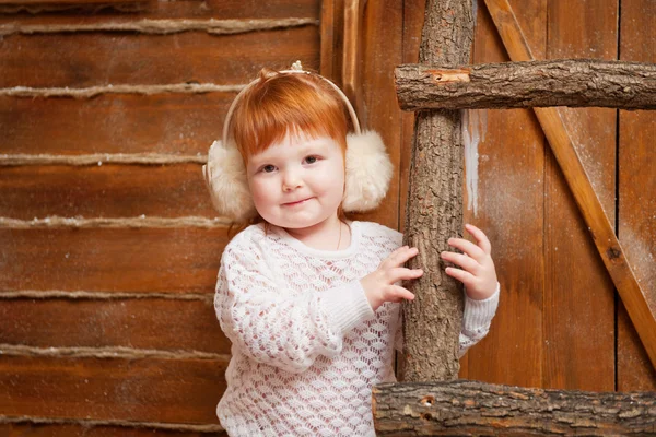 Little girl on the wooden porch — Stock Photo, Image