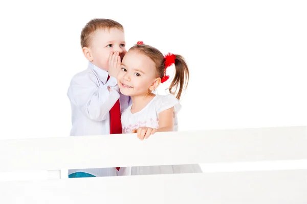 Chica y niño susurrando —  Fotos de Stock