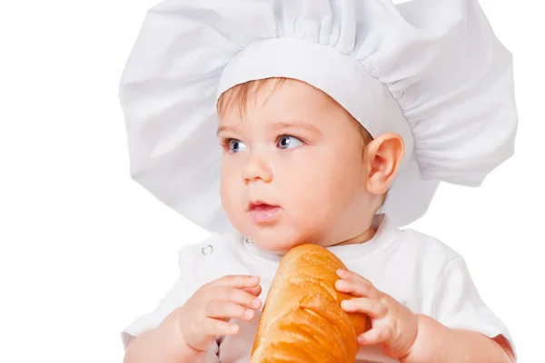 Petit garçon dans une casquette avec du pain — Photo