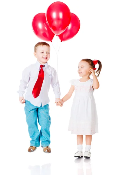 Boy and girl with the red balloons Stock Photo