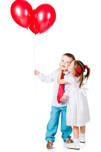 Boy and girl with the red balloons Stock Picture