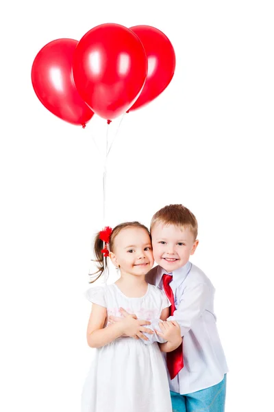 Boy and girl with the red balloons Royalty Free Stock Images