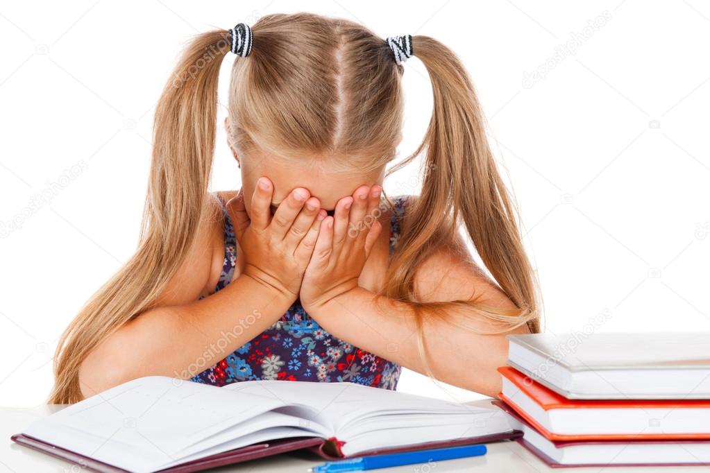 Tired little girl does homework