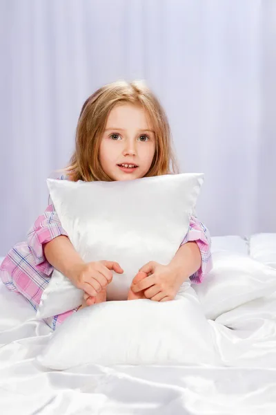 Girl in pajamas on bed — Stock Photo, Image