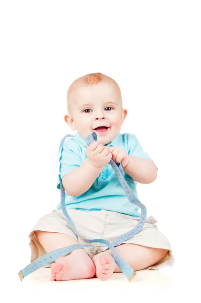 Child is sitting with a measuring meter — Stock Photo, Image