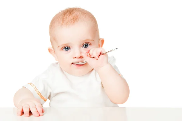 Beautiful babe eats with a spoon — Stock Photo, Image