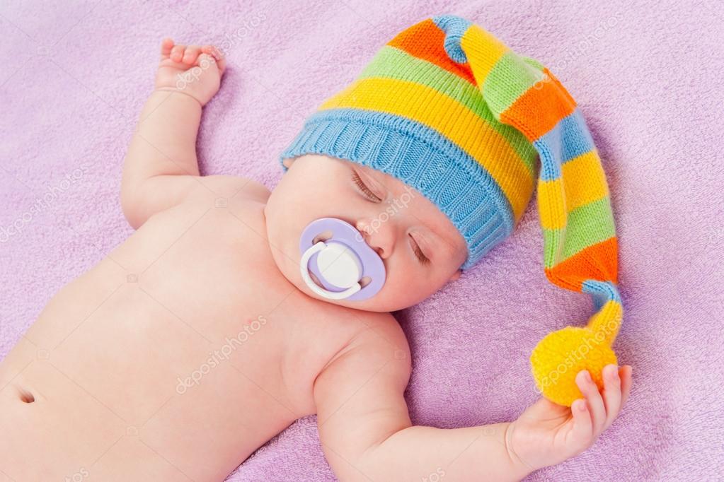 Sleeping baby with pacifier Stock Photo by ©Chirtsova 26614511