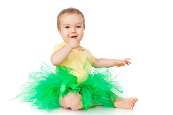 Cheerful little girl in a green skirt — Stock Photo, Image