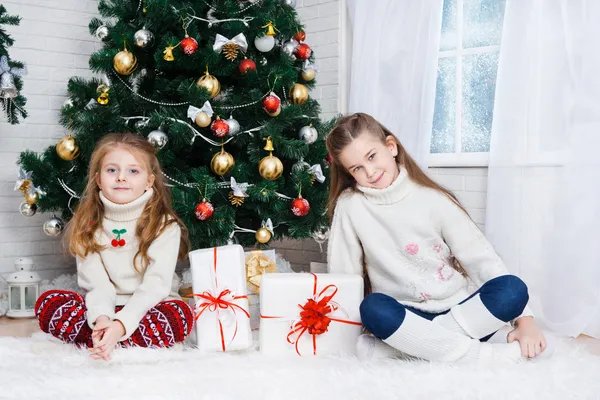 Twee kleine meisjes in een kamer met giften van Kerstmis — Stockfoto