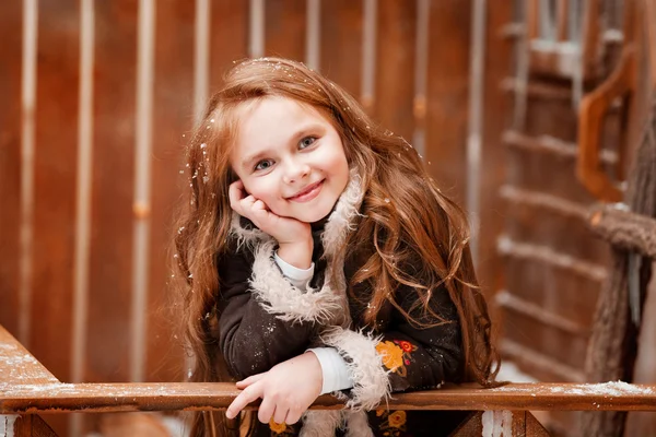 Beautiful little girl on the wooden porch — Stock Photo, Image