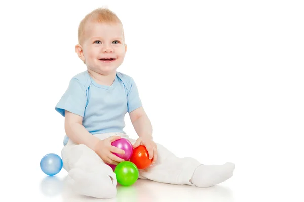 Der kleine Junge mit Spielzeugkugeln — Stockfoto