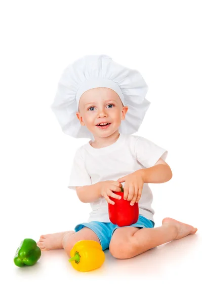 Jongen in chef-kok hoed met peper — Stockfoto