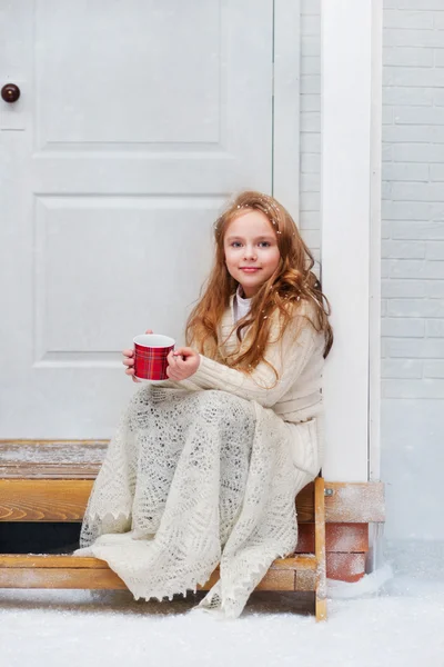 Beautiful little girl on the wooden porch — Stock Photo, Image