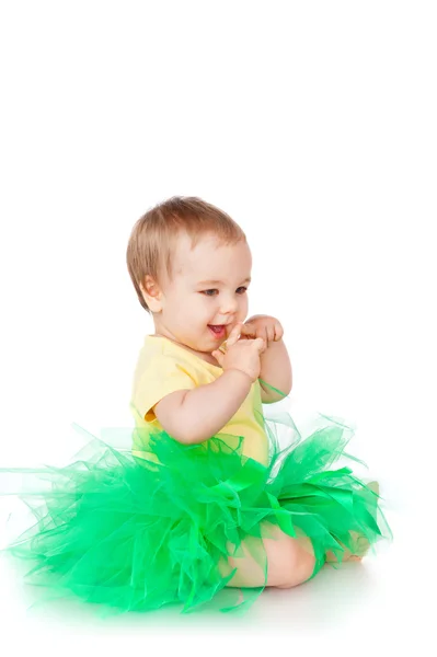 Cheerful little girl in a green skirt — Stock Photo, Image
