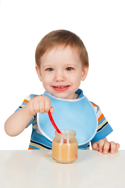 Boy eats with a spoon puree — Stock Photo, Image