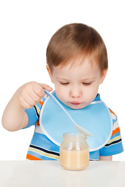 Boy eats with a spoon puree — Stock Photo, Image