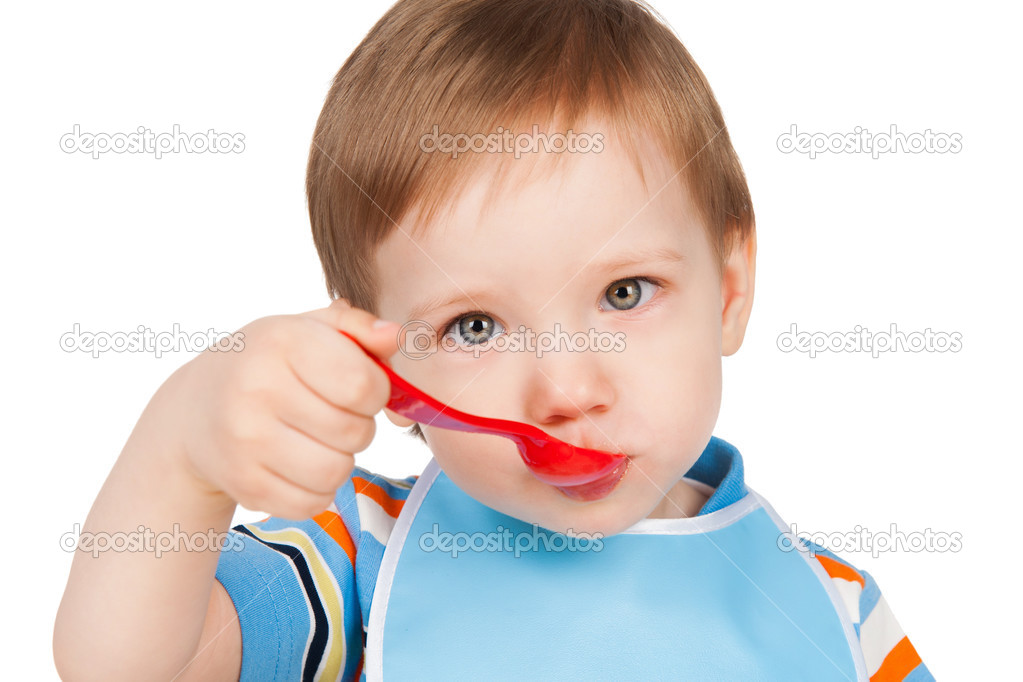 Boy eats with a spoon puree