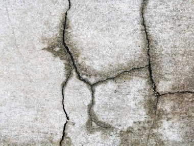 A cracked concrete wall covered with a gray cement texture as the background. and enter text.
