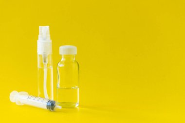 Perfume, syringes and perfume making equipment Isolated on a yellow background.