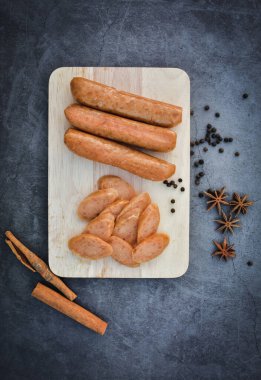 Sausage Or Guan Chiang and Herbs on the board, serving good beer snacks on a dark background.