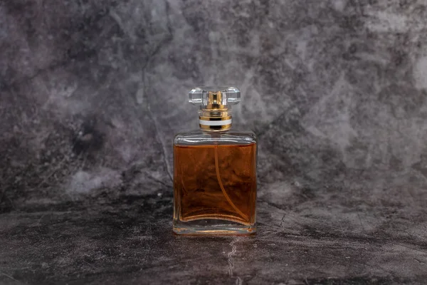 orange woman perfume on dark background