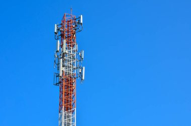 4G and 5G wireless communication antenna transmitter telecommunication tower with separate antenna on sky background.