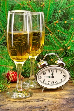 Wine glasses, watches, Christmas toys, near New Year tree. clipart
