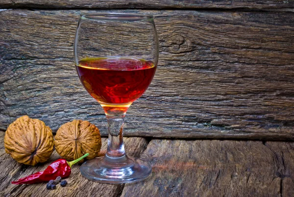 Wine glass of brandy in oak background — Stock Photo, Image