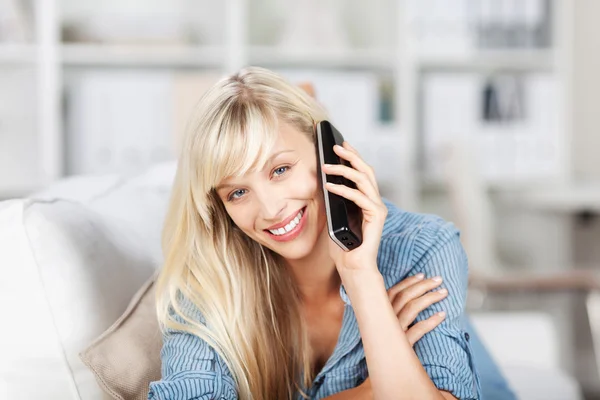 Blond female calling at home — Stock Photo, Image