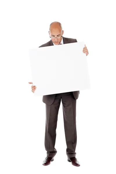Uomo d'affari guardando cartellone su sfondo bianco — Foto Stock