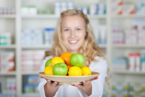 Ženské lékárník hospodářství různé ovoce — Stock fotografie