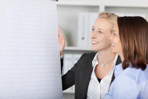 Smiling Businesswoman Standing By Flipchart — Stock Photo, Image